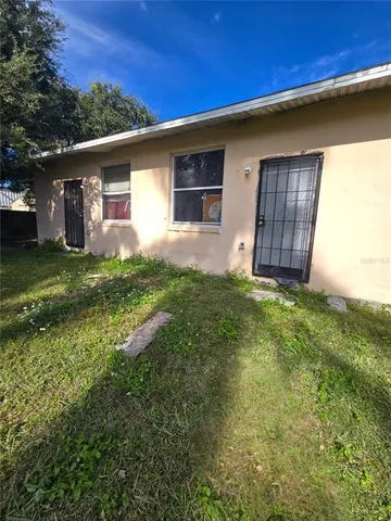 a front view of house with yard and trees