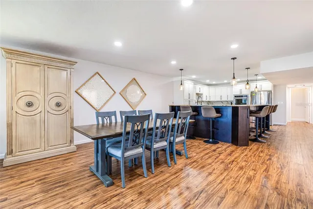 a dining room with furniture entryway and wooden floor