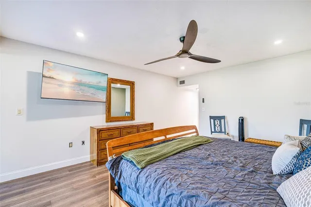 a bedroom with a bed and wooden floor