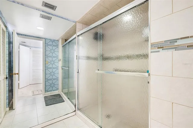 a bathroom with a shower and a glass door shower