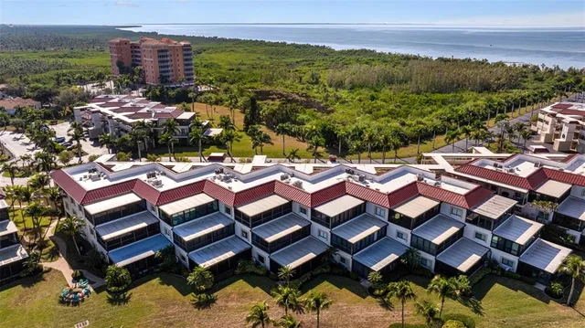 a view of a patio with table and chairs with wooden floor and lake view