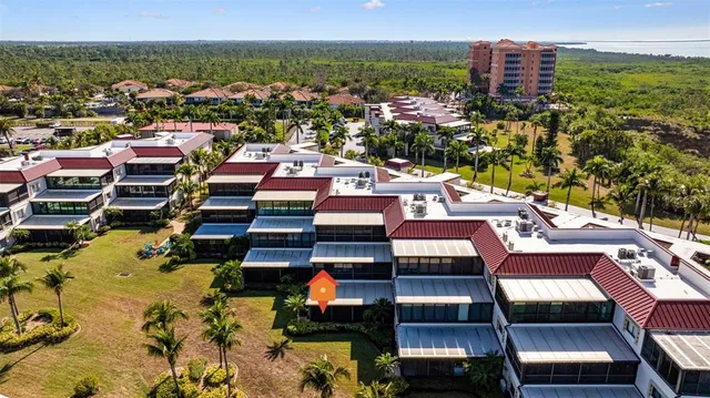 a kitchen with kitchen island stainless steel appliances a stove refrigerator sink cabinets dining table and chairs