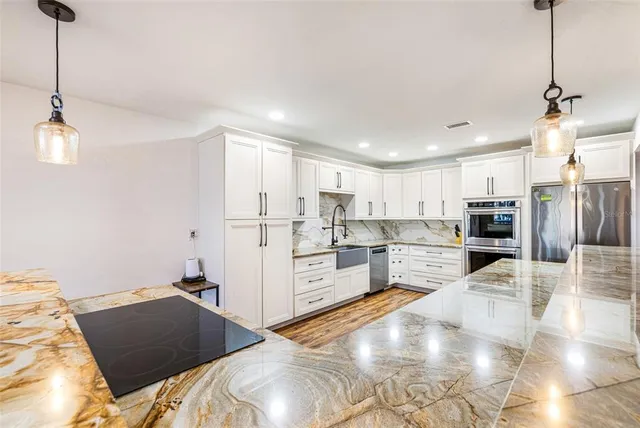 a kitchen with stainless steel appliances refrigerator and microwave
