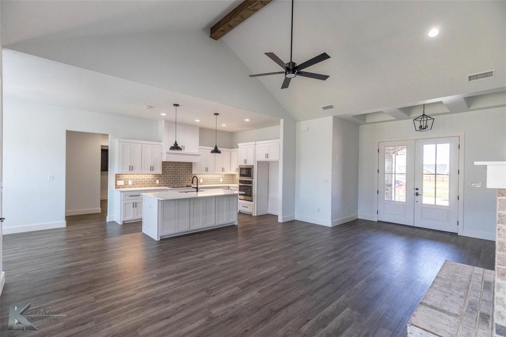3325 Ace Abilene, TX 79606 - Photo 11 of 40 a room with stainless steel appliances kitchen island wooden floors refrigerator and window