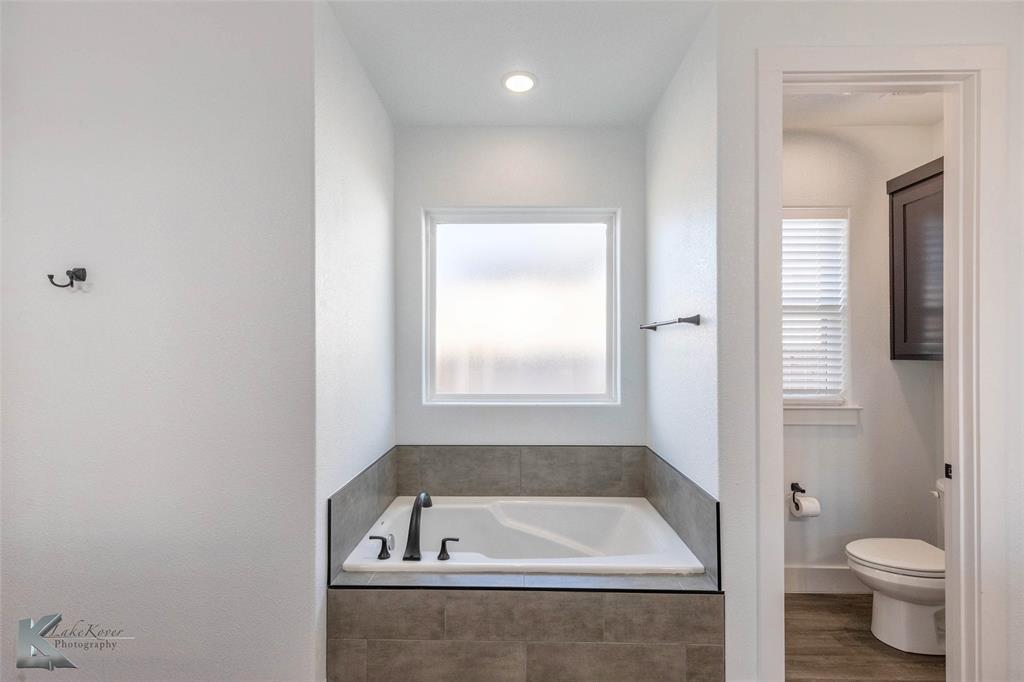3325 Ace Abilene, TX 79606 - Photo 24 of 40 a bathroom with a tub and toilet