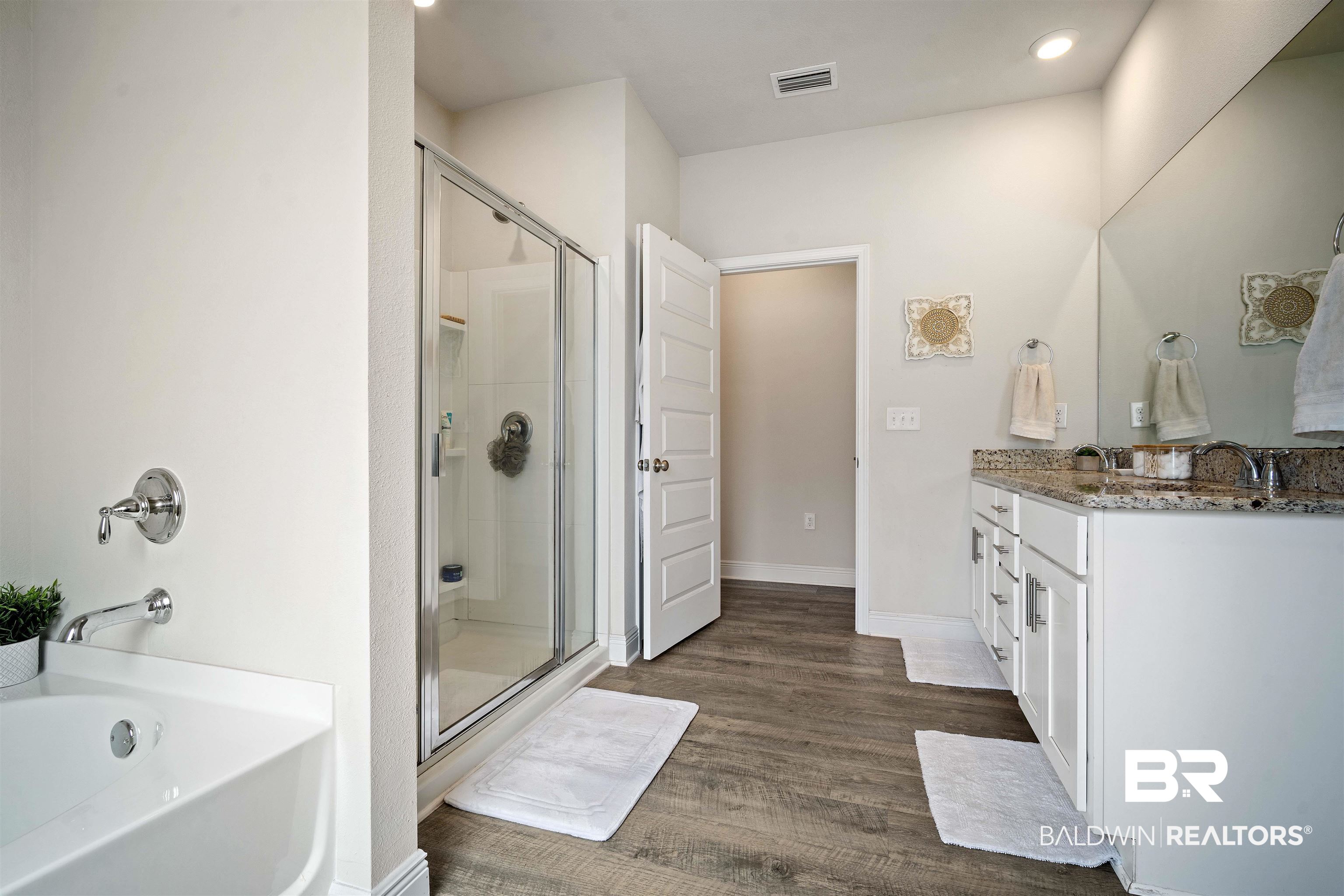 11021 Native Dancer Way Daphne, AL 36526 - Photo 13 of 35 Full bathroom with a tub to relax in, wood finished floors, visible vents, vanity, and a stall shower