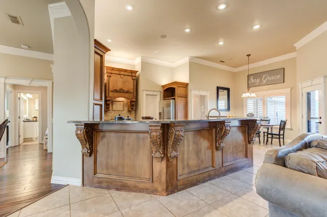 a large kitchen with stainless steel appliances a stove and a sink