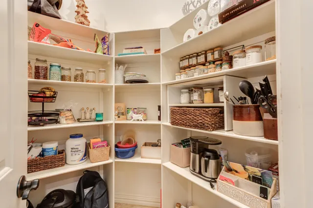 a work room with furniture a flat screen tv and a window