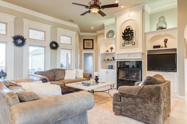 a living room with furniture and a chandelier