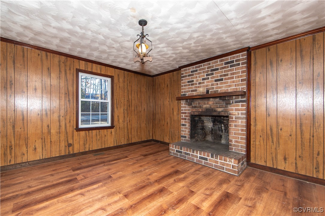 2015 Hicks Road Richmond, VA 23235 - Photo 16 of 31 Unfurnished living room featuring wood walls, hard