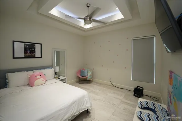 a bedroom with a bed and a chandelier