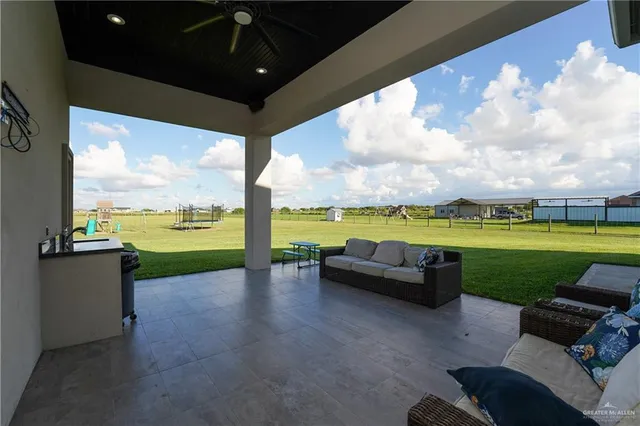 a view of a couches in the patio next to a yard