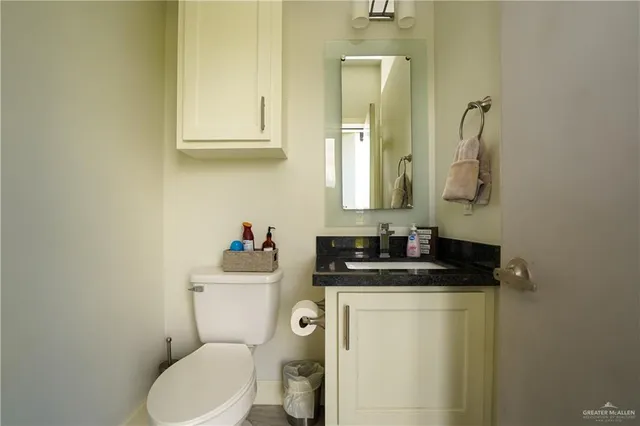 a bathroom with a toilet a sink and mirror