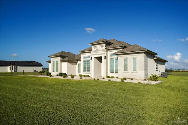 a front view of a house with a garden