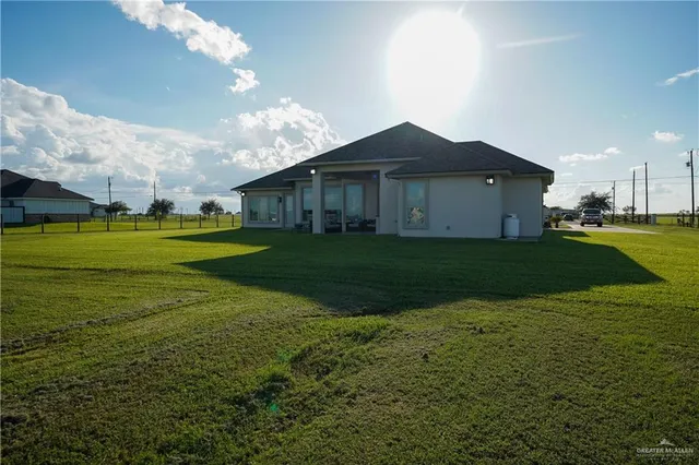 a front view of house with yard and green space