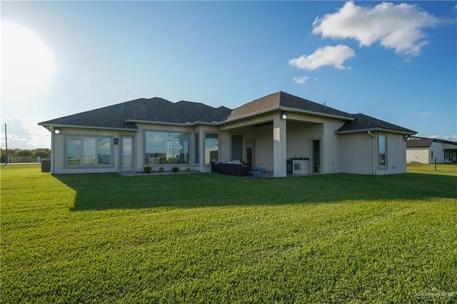 a view of a house with a backyard