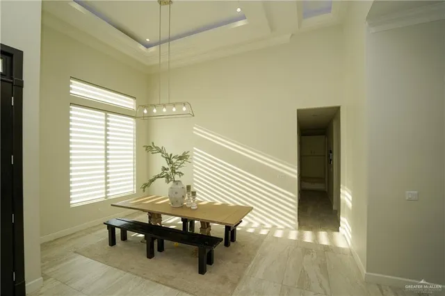 a kitchen with stainless steel appliances kitchen island granite countertop a refrigerator a stove a sink a dining table and chairs with wooden floor