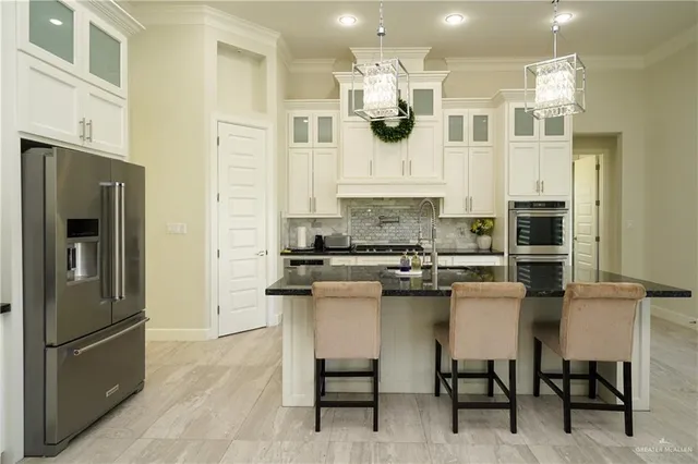 a kitchen with a sink and living room view