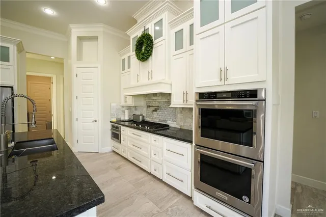 a kitchen with stainless steel appliances granite countertop a stove and a sink