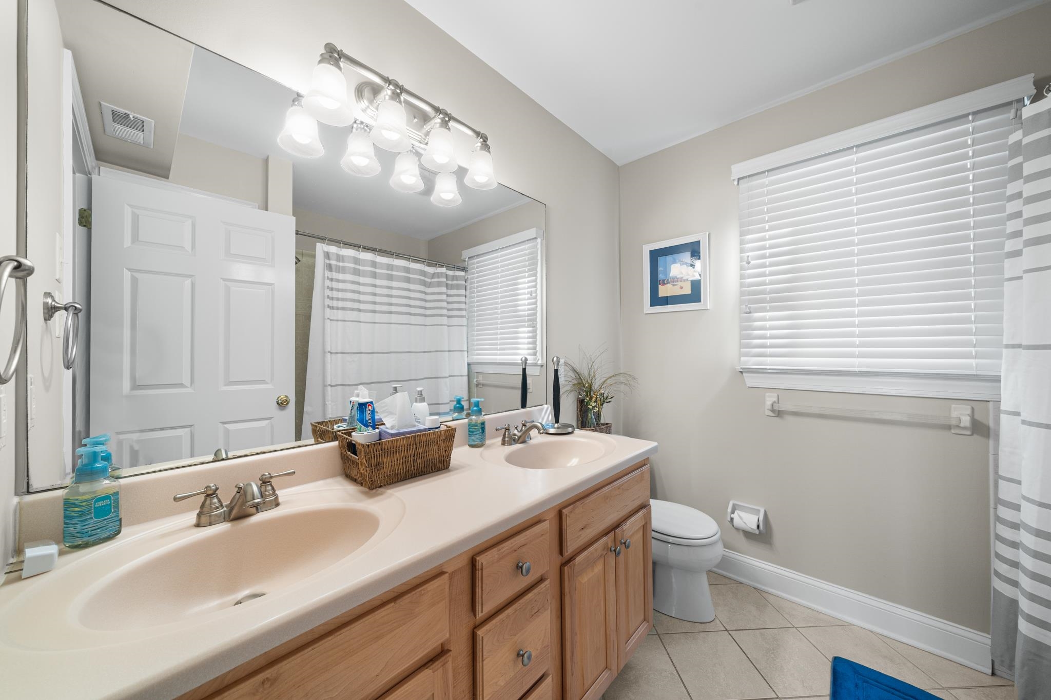 55 West 29th Avalon, NJ 08202 - Photo 22 of 32 a bathroom with a double vanity sink toilet and a mirror