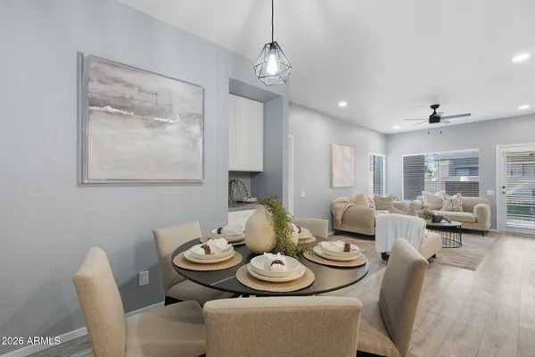 a dining room with furniture and wooden floor