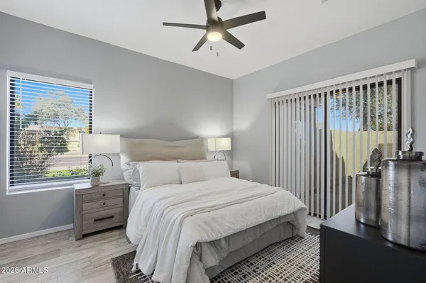 a bedroom with a bed a dresser and a window