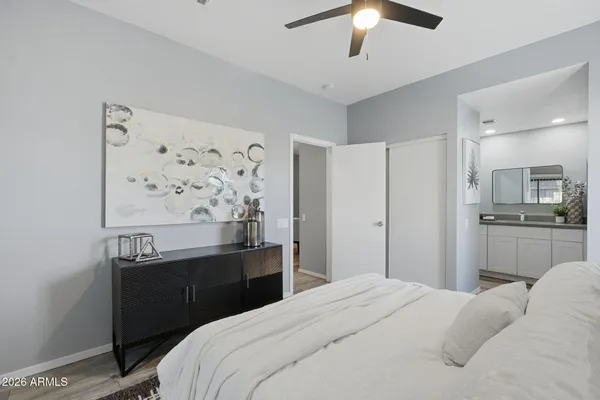 a bedroom with a bed and a chandelier