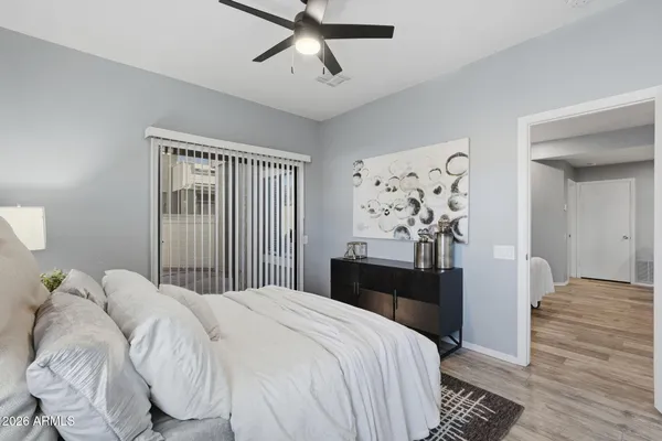 a bedroom with a bed and wooden floor