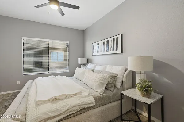 a bedroom with a bed and a table