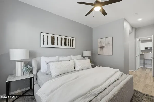 a bedroom with a bed and painting on the wall