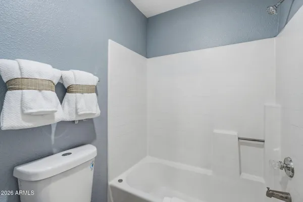 a bathroom with a toilet and a bathtub