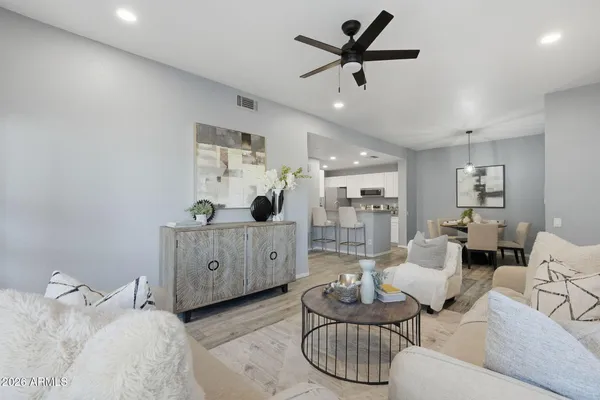a living room with furniture and view of kitchen