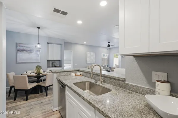 a kitchen with a sink cabinets and wooden floor
