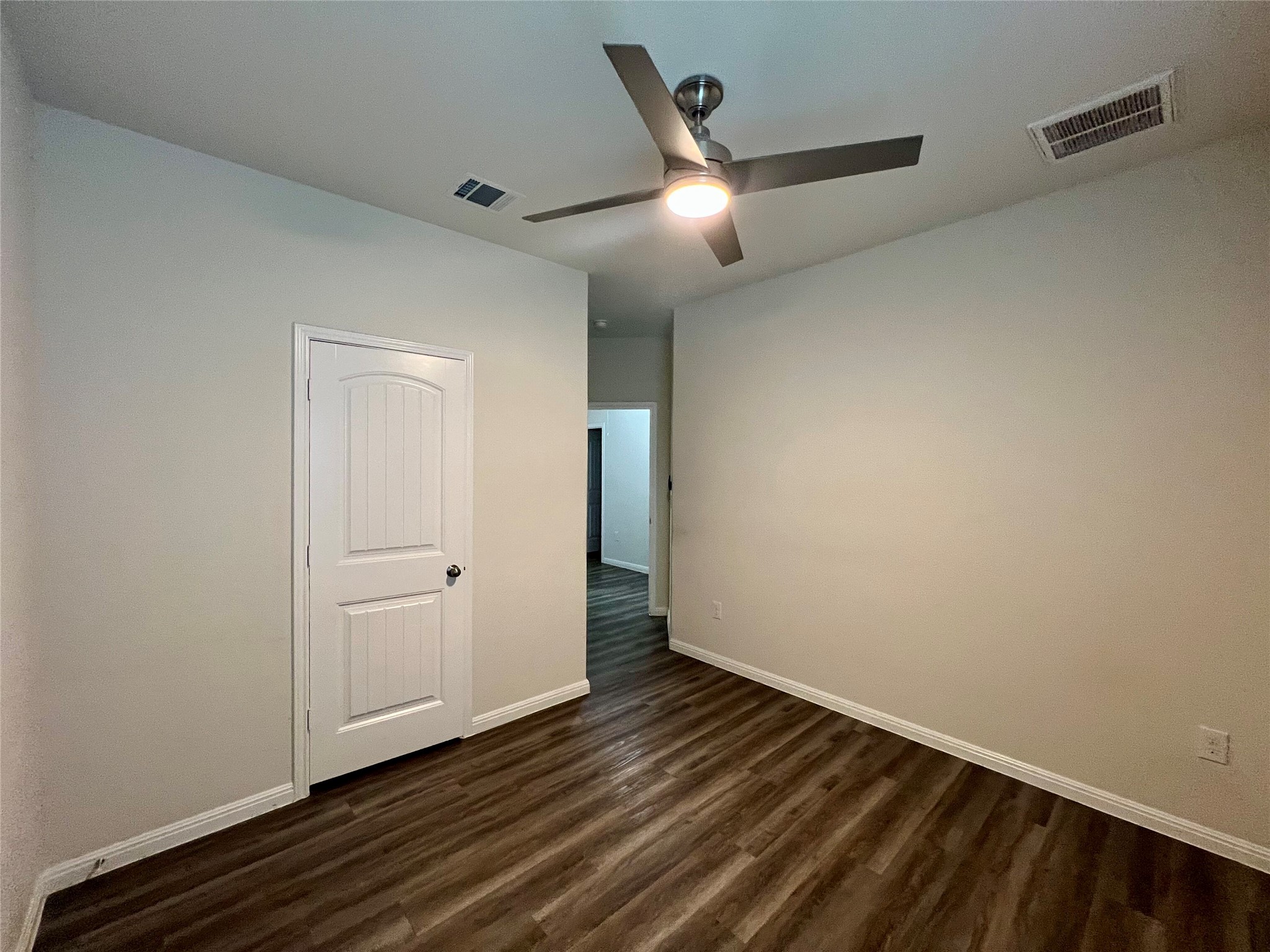 104 Moravia Road Georgetown, TX 78626 - Photo 32 of 36 A well-lit bedroom featuring durable wood flooring and a modern ceiling fan for comfort.