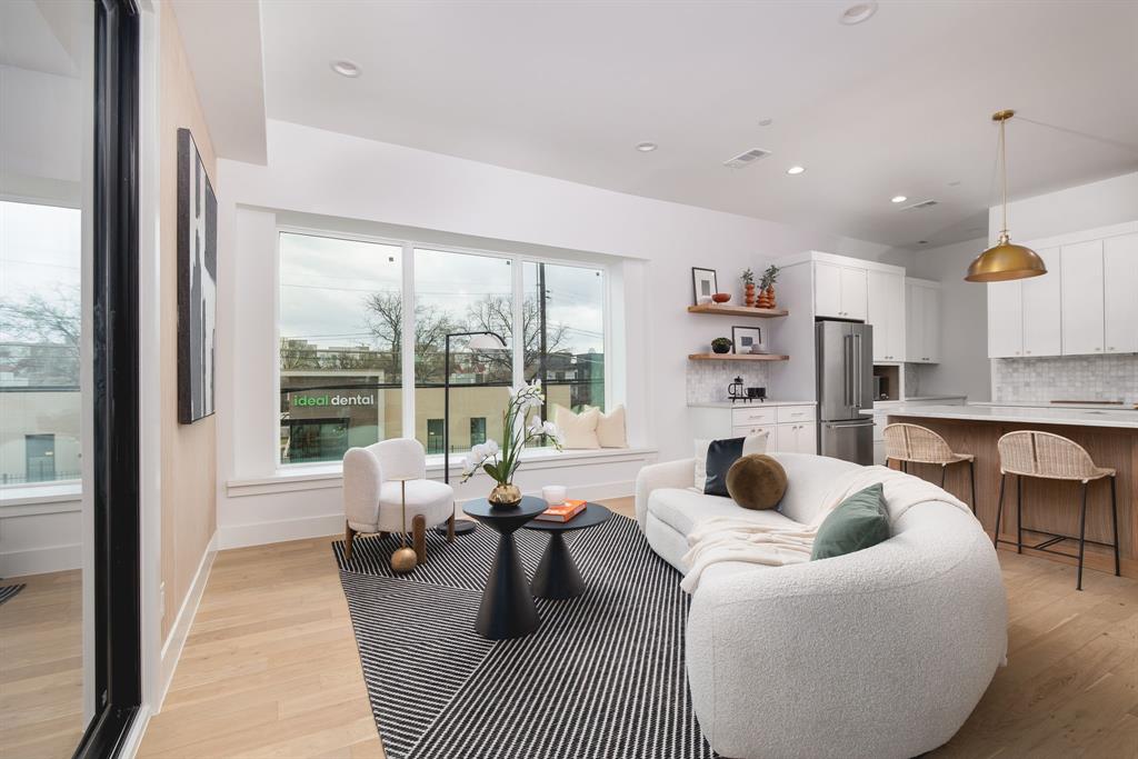 4303 Cedar Springs Road, Unit 106 Dallas, TX 75219 - Photo 15 of 35 a living room with furniture and a large window