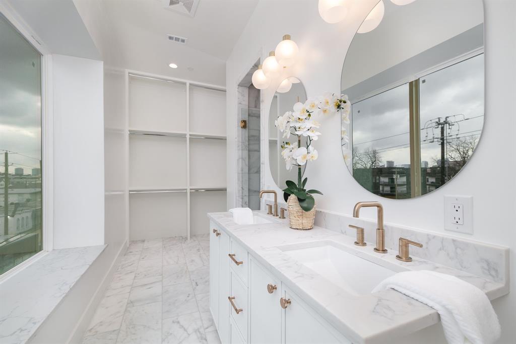 4303 Cedar Springs Road, Unit 106 Dallas, TX 75219 - Photo 25 of 35 a bathroom with a sink vanity and a mirror
