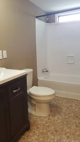 a bathroom with a toilet a sink and shower