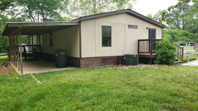 a view of backyard of house with green space
