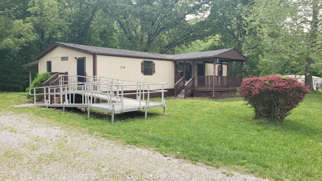 a view of a house with a yard and deck