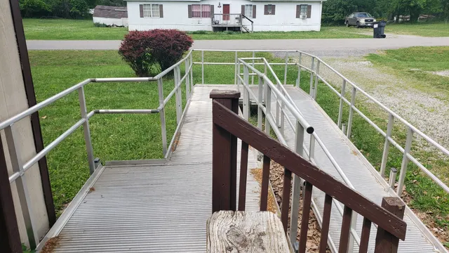a view of a balcony with two chairs and a yard