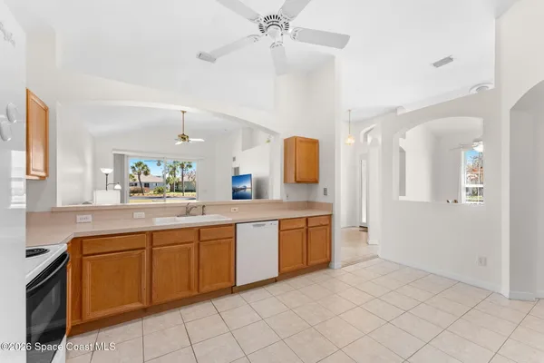a large kitchen with a sink and cabinets