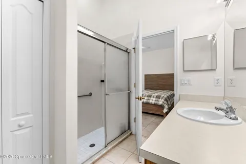 a bathroom with a sink double vanity and glass door