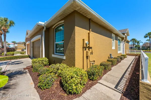 a view of a house with wooden floor and potted plants