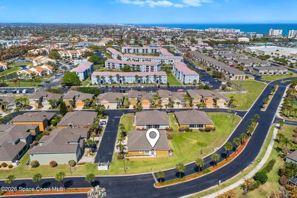 an aerial view of residential houses with outdoor space and swimming pool