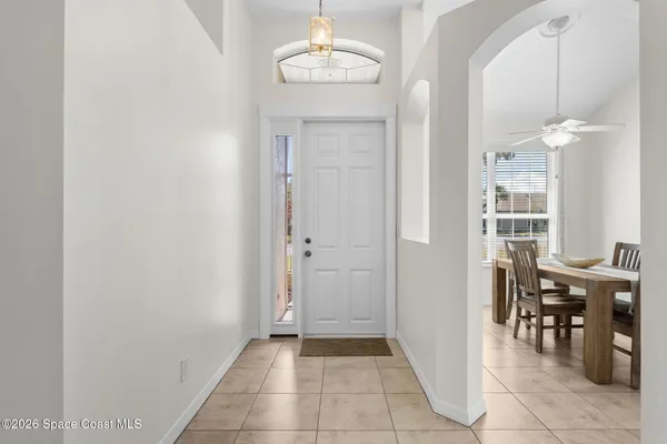 a view of a dining room with furniture and a chandelier