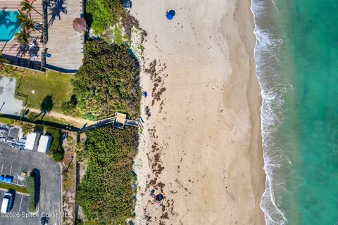 a view of a house with swimming pool and sitting area