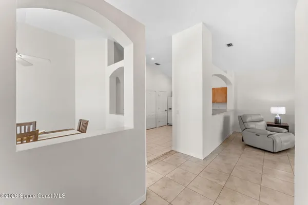 a hallway with a couch and chandelier