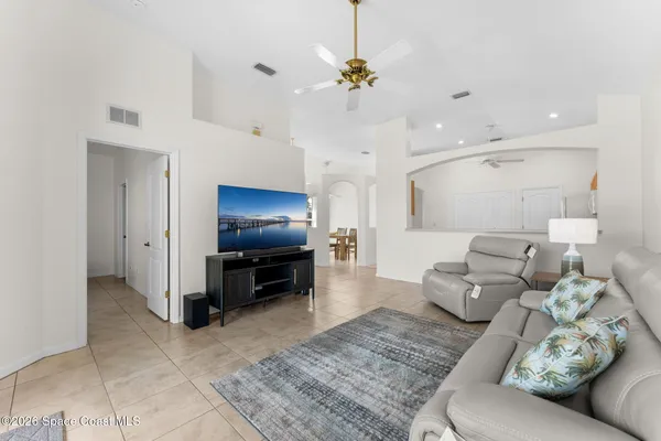 a living room with furniture and kitchen view