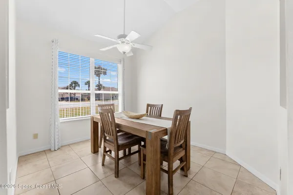 a view of a dining room with furniture and a chandelier