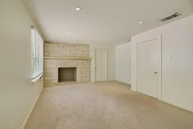 a view of an empty room with a fireplace